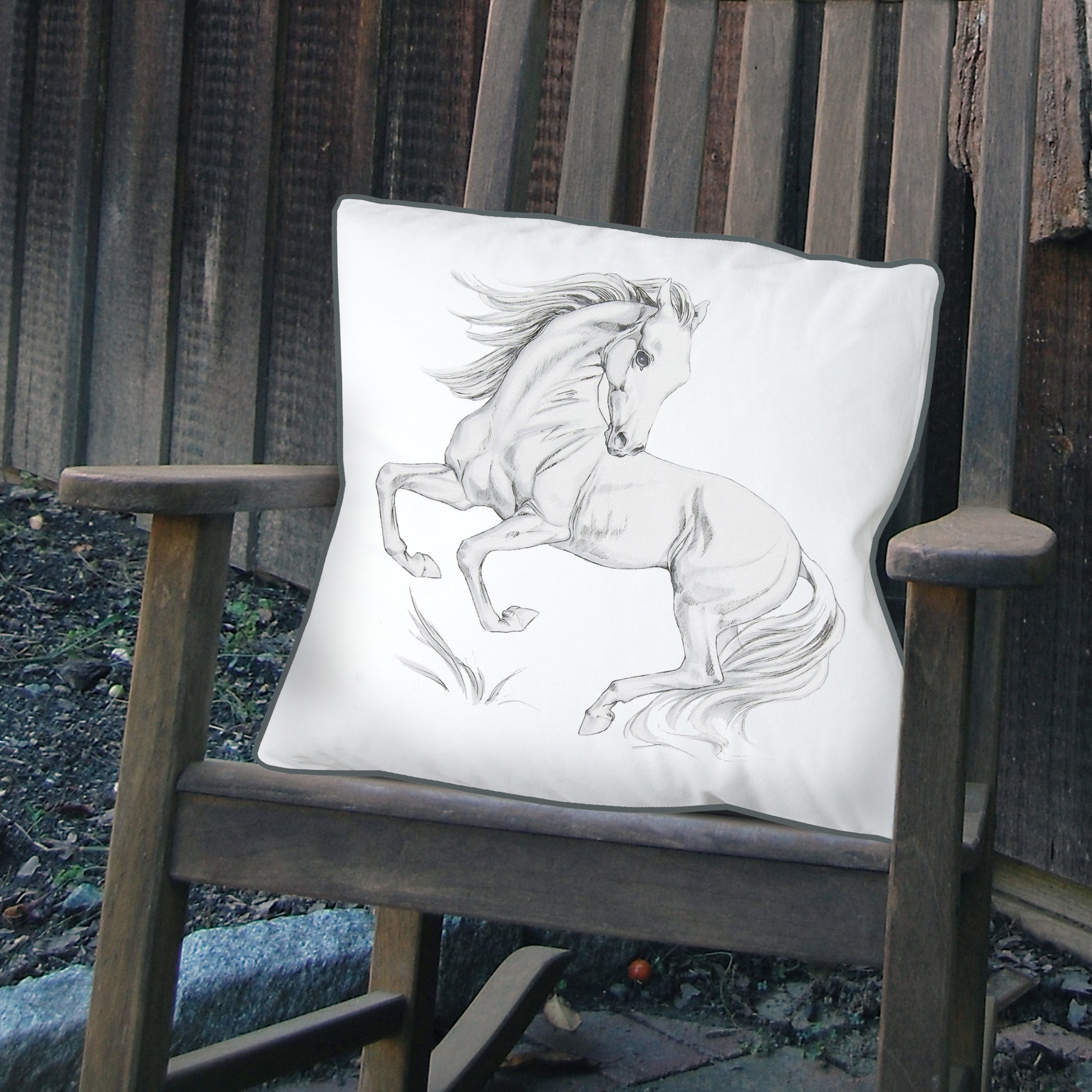 Equine Pesade Indoor Outdoor Pillow styled on an outdoor rocking chair.