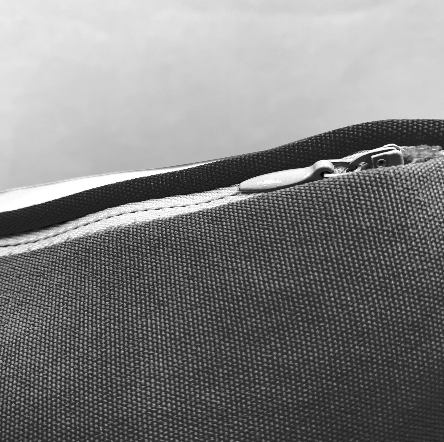 Detail shot of the Head Strong Left pillow zipper.