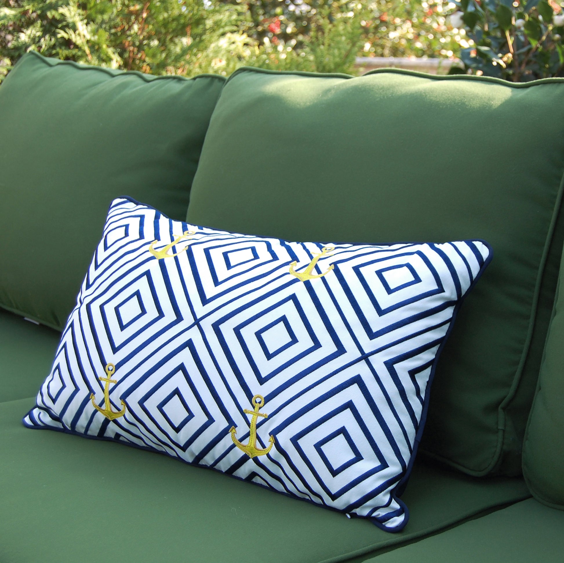 Geo Pattern Nautical pillow styled on a green outdoor couch.