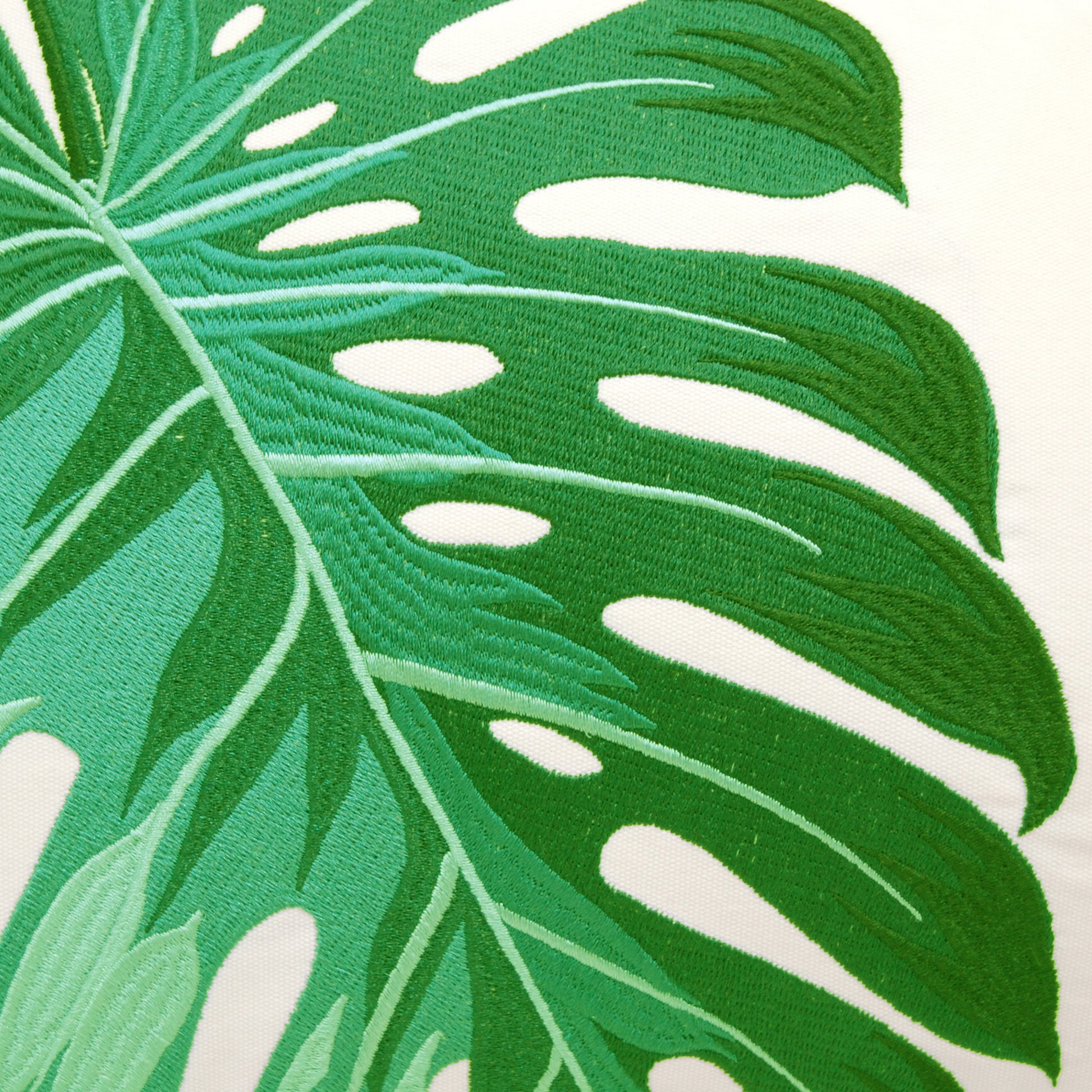 Detail shot of the Green Monstera Lumbar pillows embroidery
