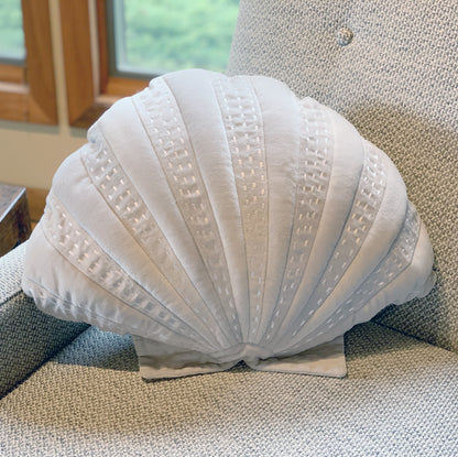 Grey Velvet Shaped Scallop pillow styled on a tweed couch.