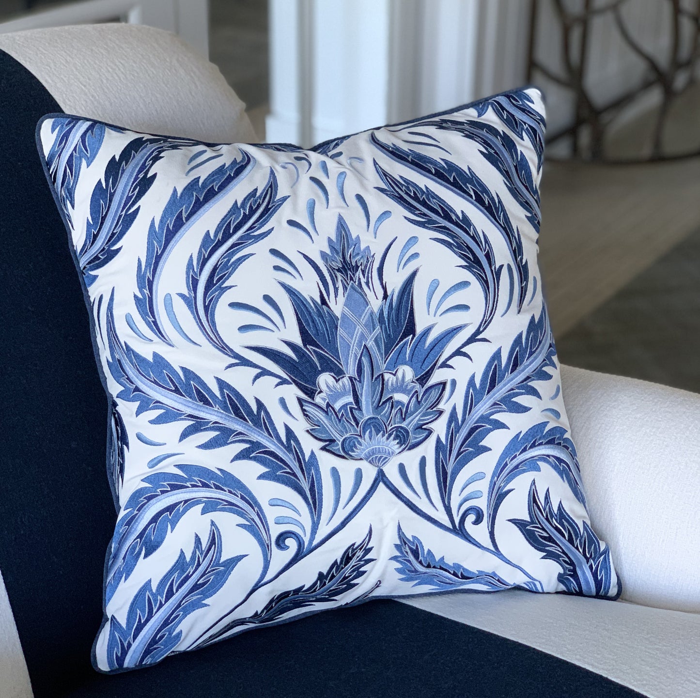 Indigo Morrie Thistle pillow styled on a chair.