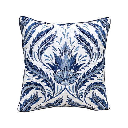 Traditional thistle design in various hues of blue embroidered on a white background. Finished with blue piped edging.