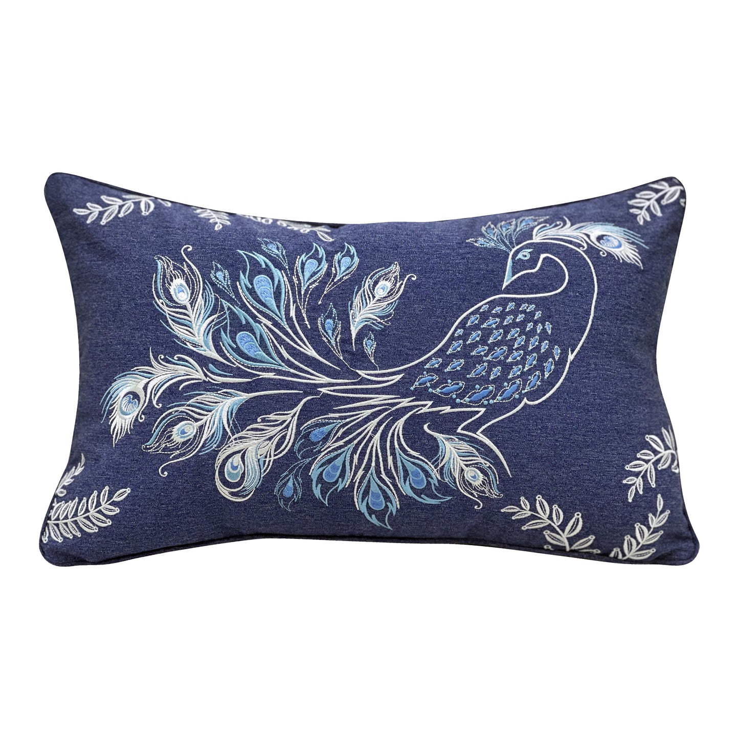 A fancy peacock emboridered in hues of blue and white on a navy background. Sprigs of leaves frame the pillow at each corner.