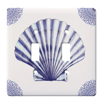 white ceramic double toggle switch plate featuring blue scallop shell and blue decorative corners.