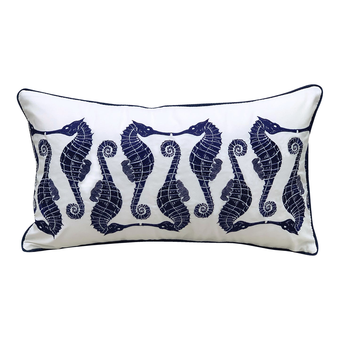 Indigo seahorses in an alternating pattern embroidered on a white background. Pillow is finished with blue piped edges.