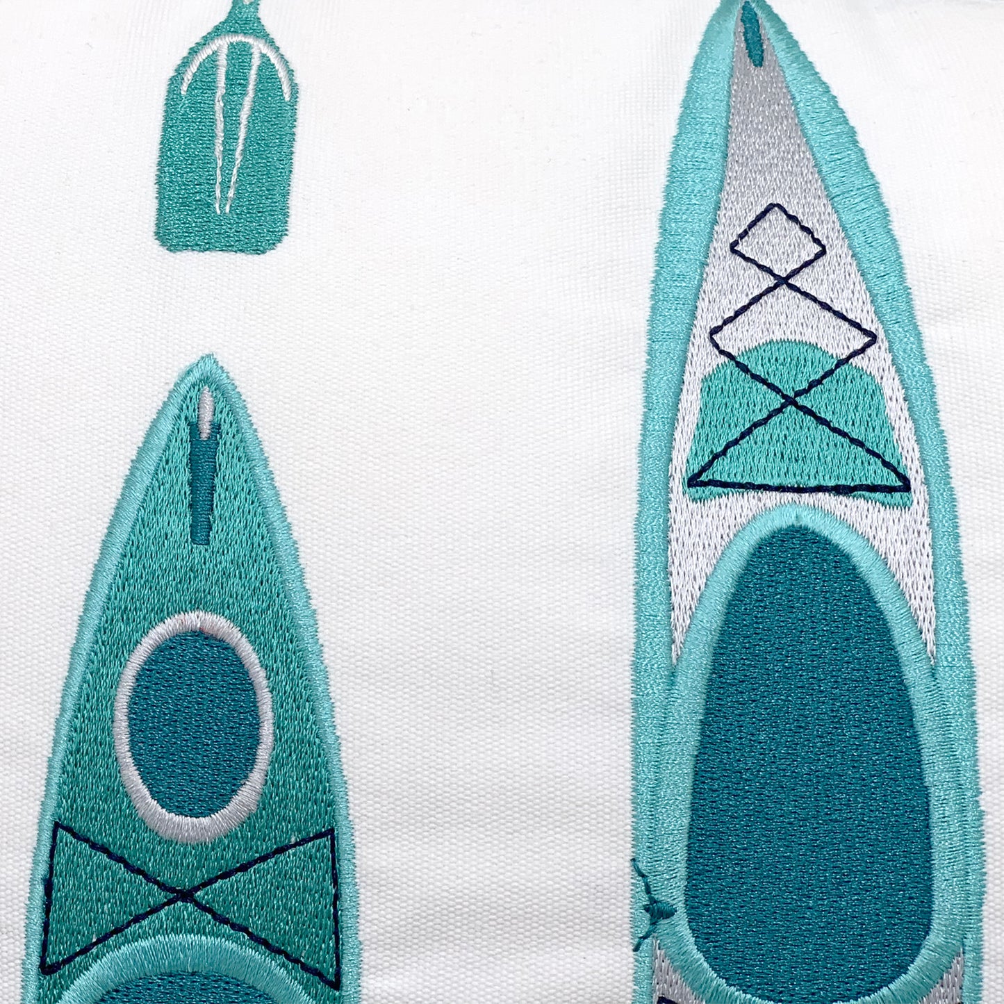 Detail shot of the Kayak Pattern Indoor Outdoor Pillow embroidery.