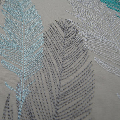 Detail shot of the embroidered feathers on the Lake Feather Pattern Pillow.
