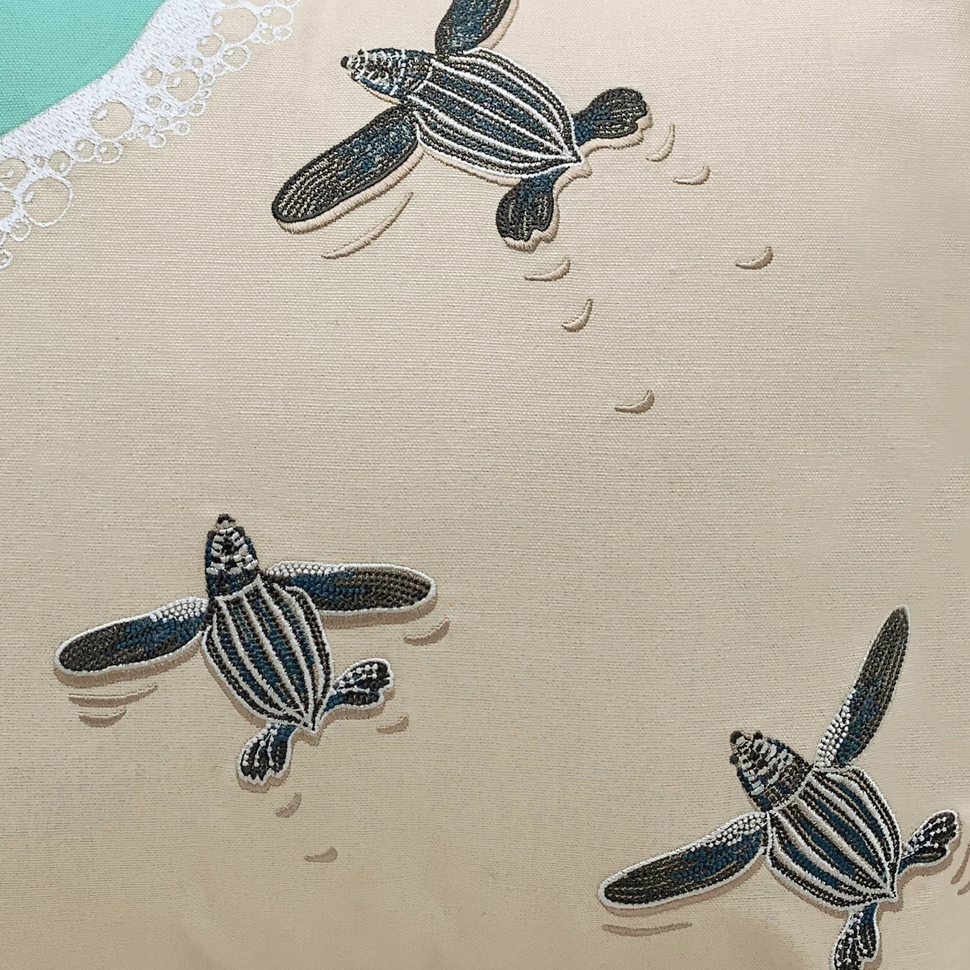 Detail shot of the Leatherback Turtle Pillows embroidery.