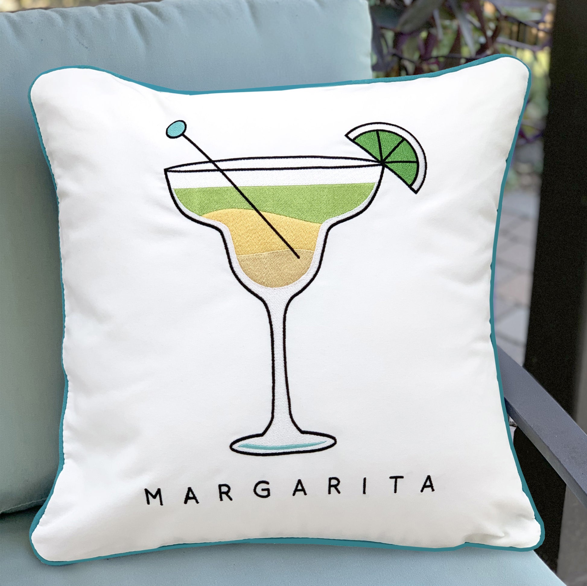 Margarita Indoor Outdoor Pillow styled on an outdoor pillow.