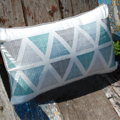 Modern Lake Triangle Lumbar pillow styled on a wooden bench.