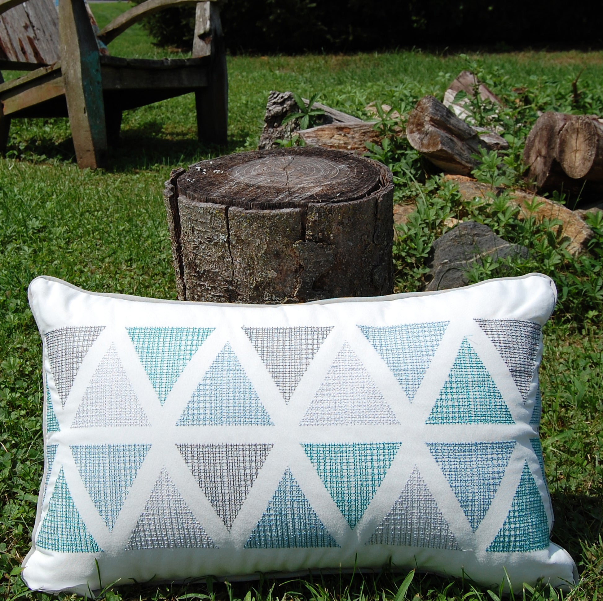 Modern Lake Triangle Lumbar pillow styled outside.