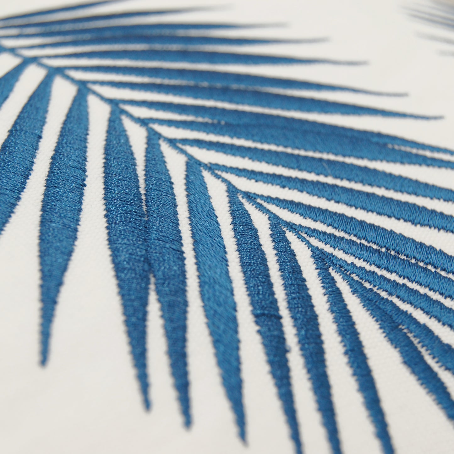 Detail shot of the Palm Pattern Lumbar Pillow's embroidery work.
