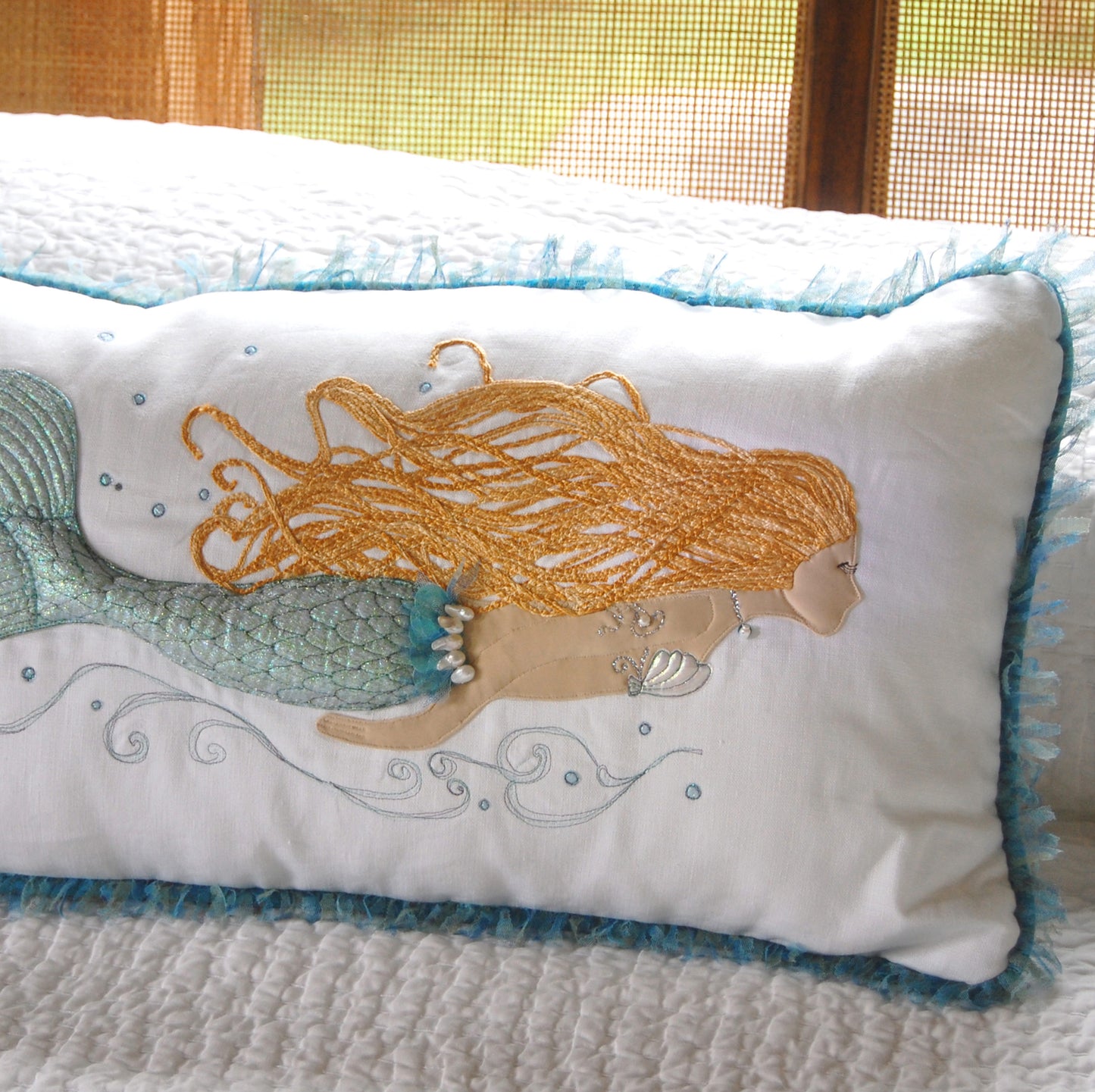 Pearl of the Sea Mermaid Lumbar Pillow styled on a bed.