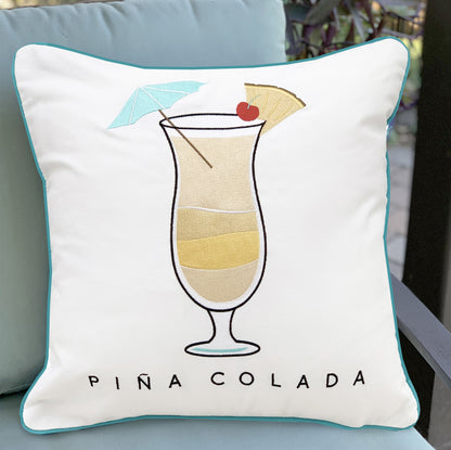 Pina Colada Indoor Outdoor pillow styled on an outdoor chair.