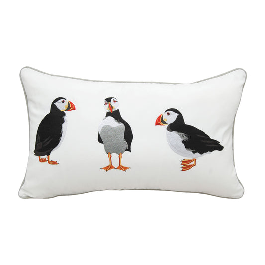 Three puffins embroidered on a white background. Pillow is finished with grey piped edging.