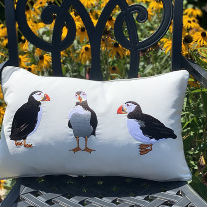 Puffin Party Lumbar Pillow styled on a rod-iron chair.