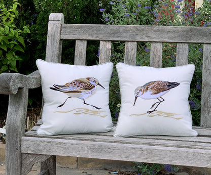 Coordinating sand piper indoor outdoor pillows styled on a garden bench.