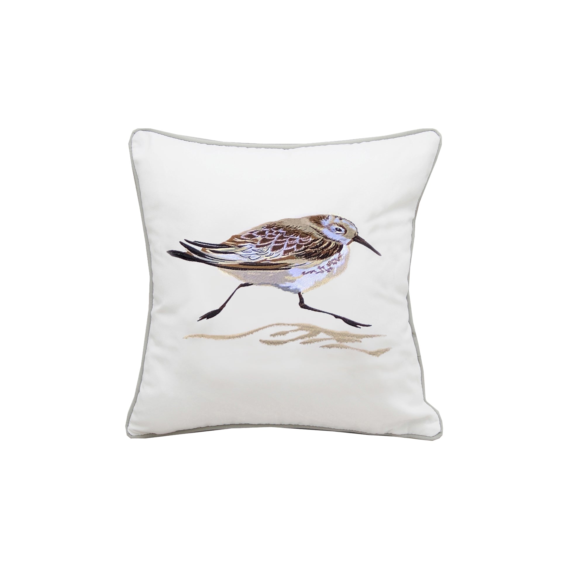 A sandpiper running across the sand embroidered on a white background. Pillow finished with grey piped edging.