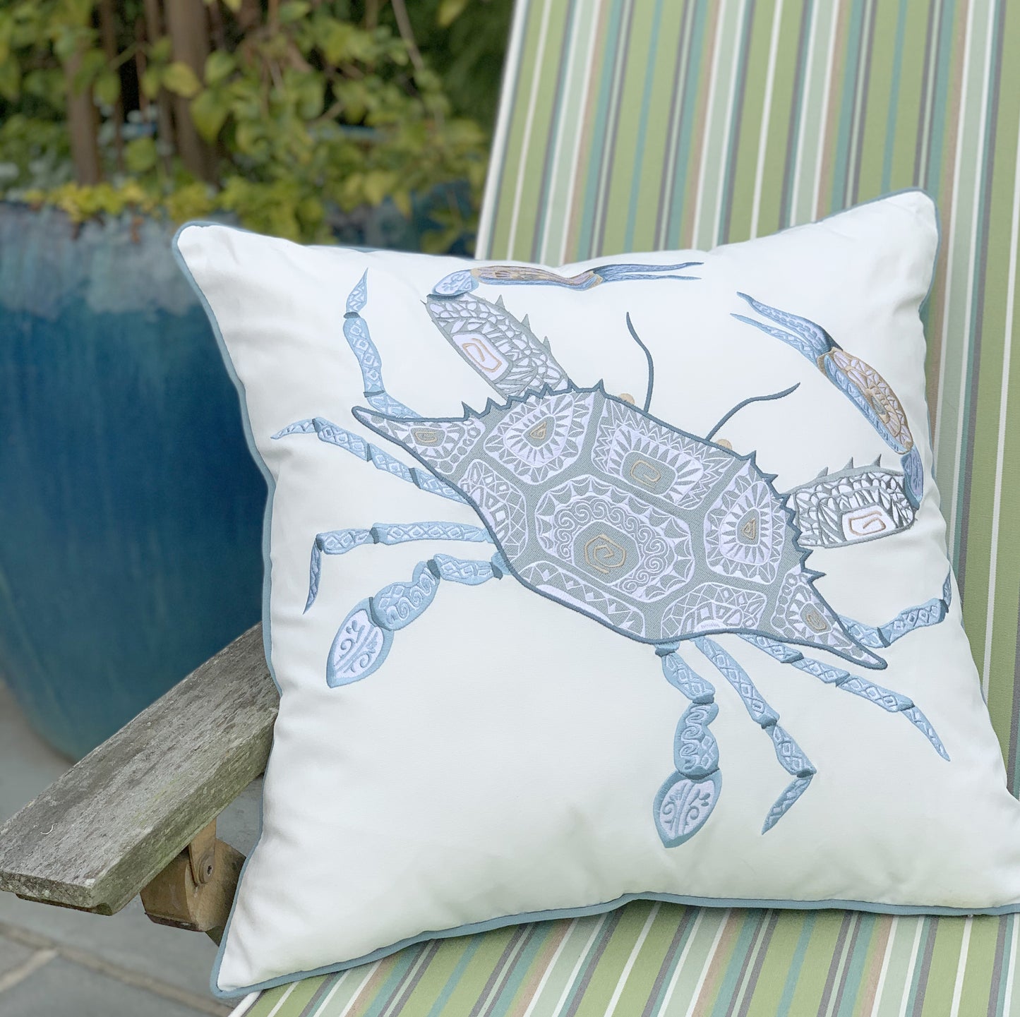 Sea Glass Tribal Crab pillow styled on a patio chair.
