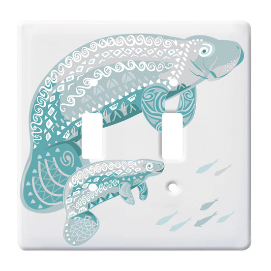 white double toggle switch plate featuring two blue manatees, one small one large. also featuring a small group of fish swimming in the opposite direction.