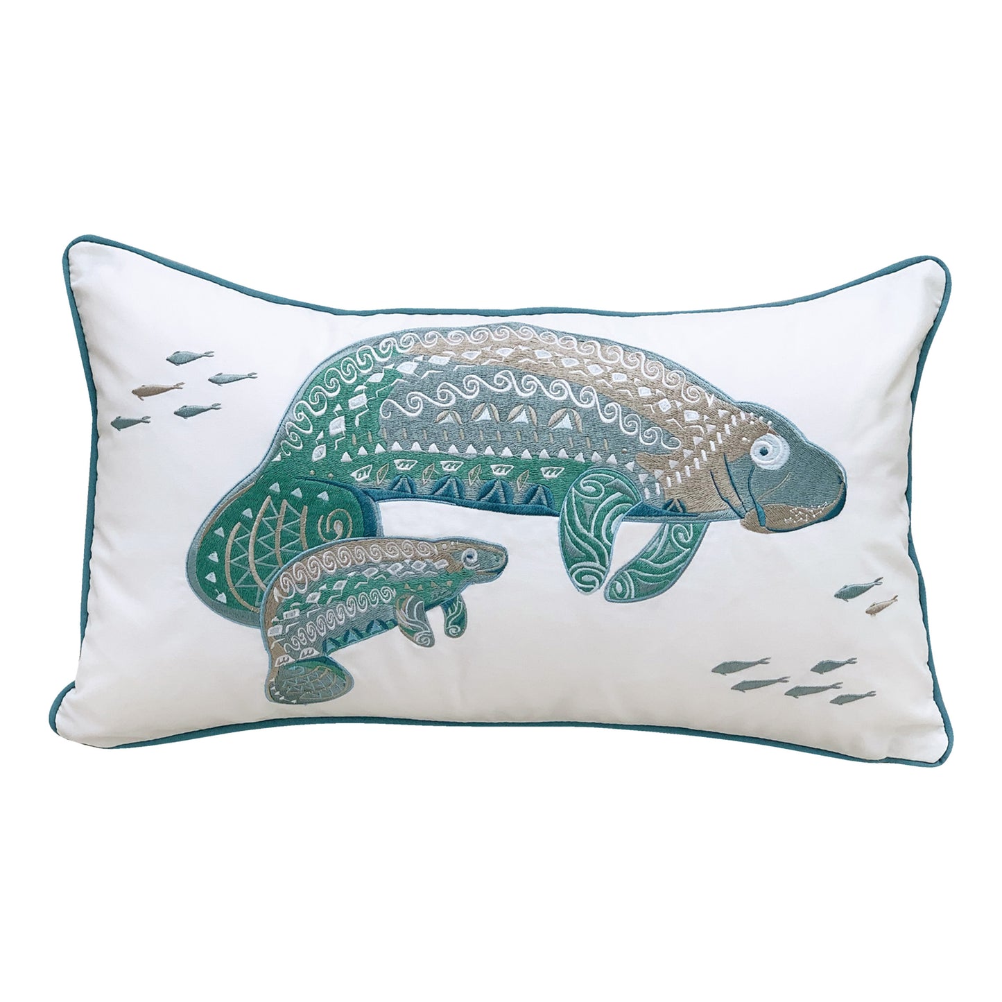 A mother and baby manatee featuring tribal designs is embroidered on a white background. Pillow is finished with blue piped edging.