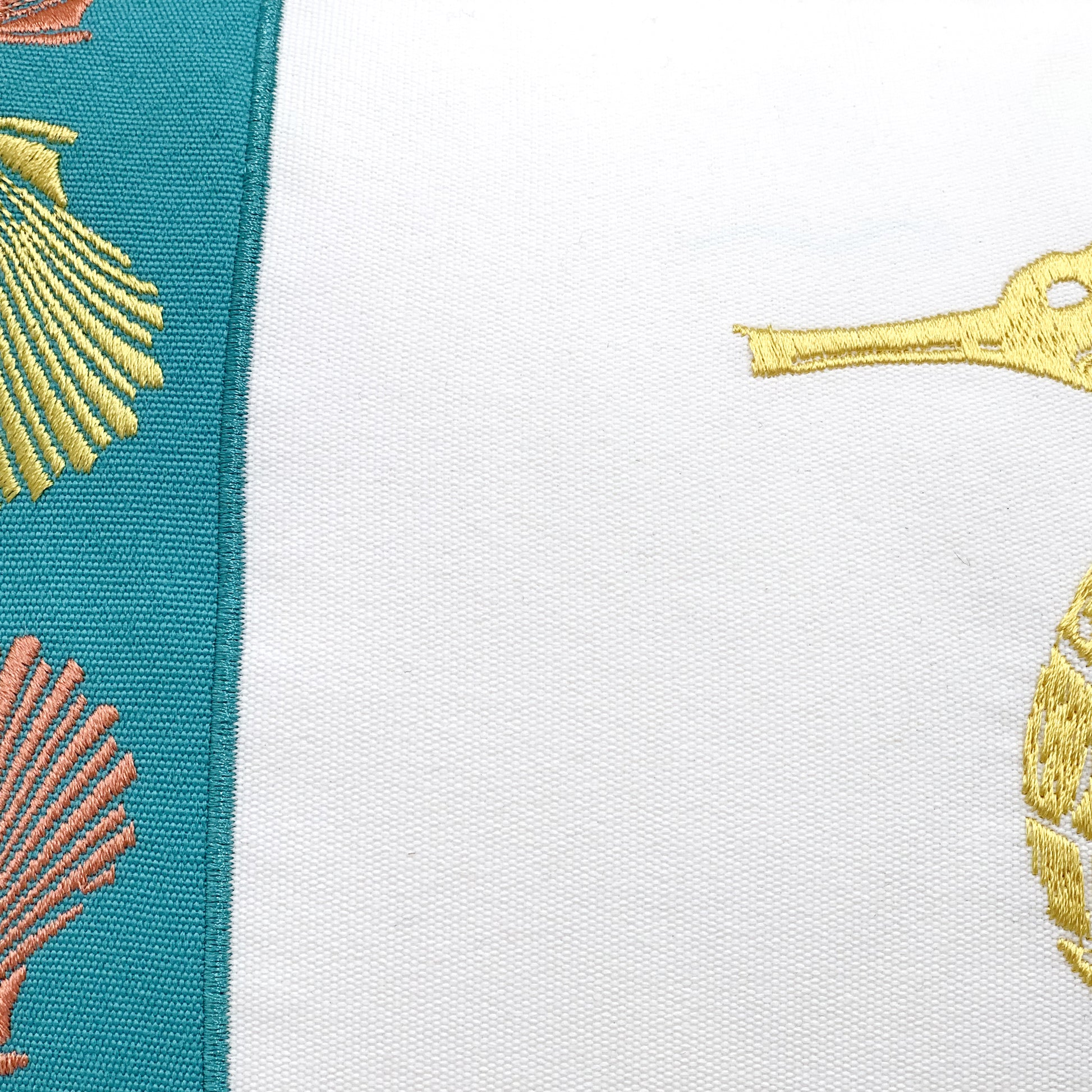 Detail shot of the Seahorse Pattern indoor outdoor pillow's embroidery work.