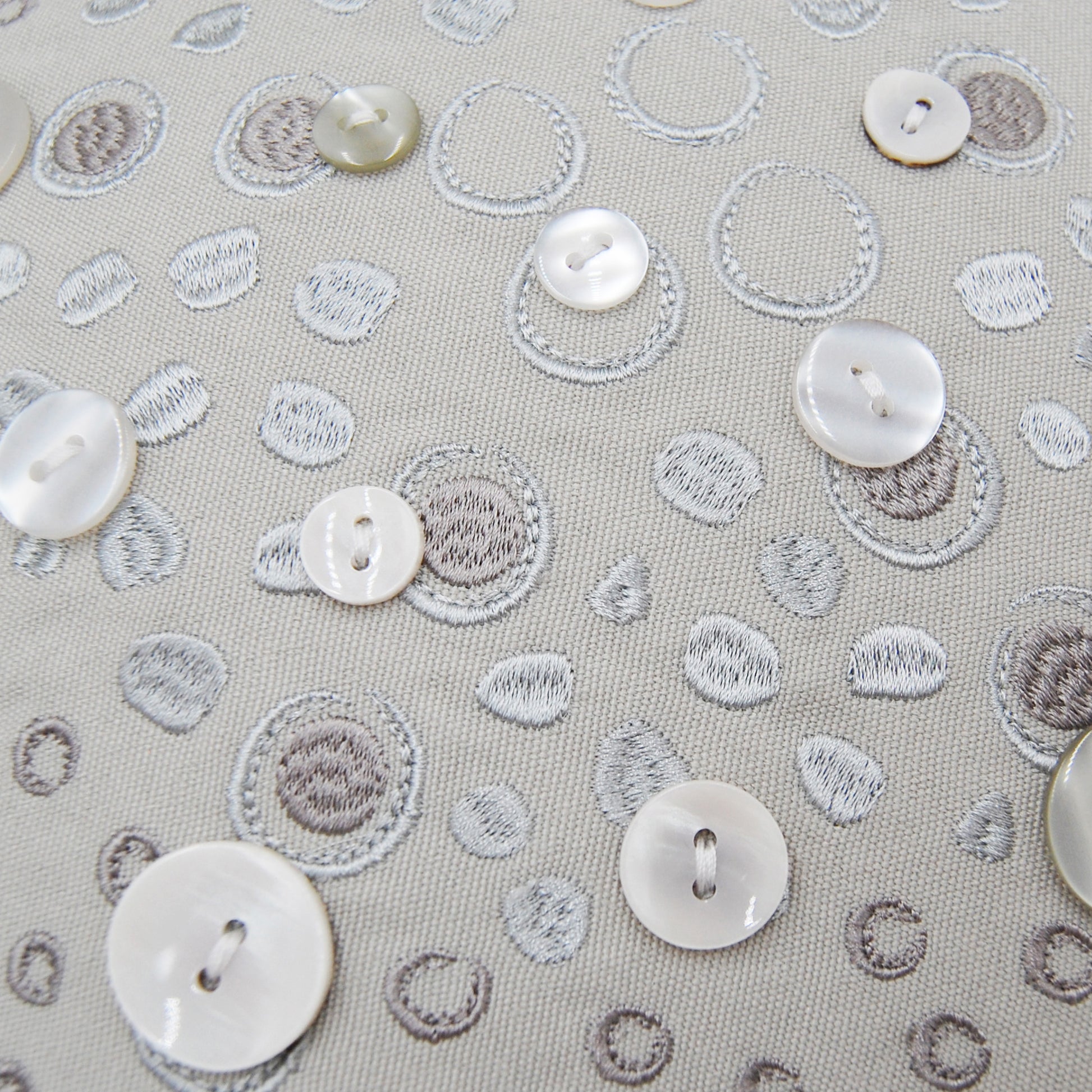 Detail shot of the embroidery work and beaded accents on the Silver Shaped Sea Star pillow.