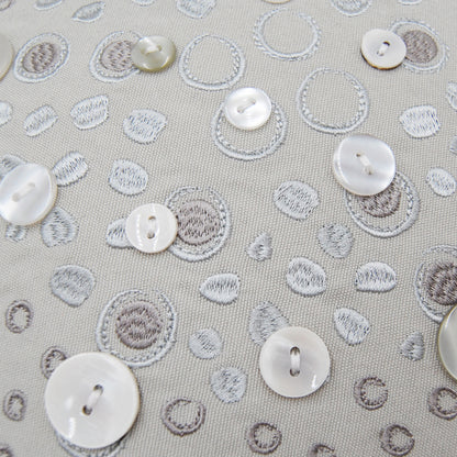 Detail shot of the embroidery work and beaded accents on the Silver Shaped Sea Star pillow.