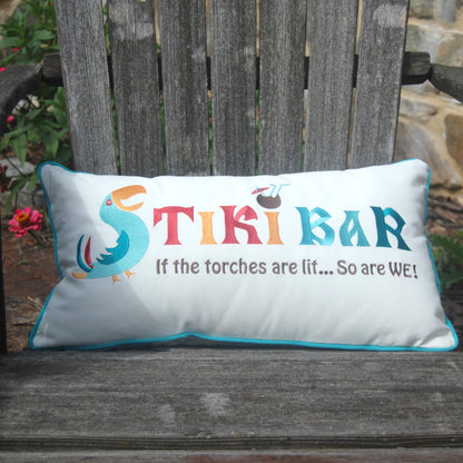 Tiki Bar Lumbar Indoor Outdoor Pillow styled on a wood Adirondack chair.