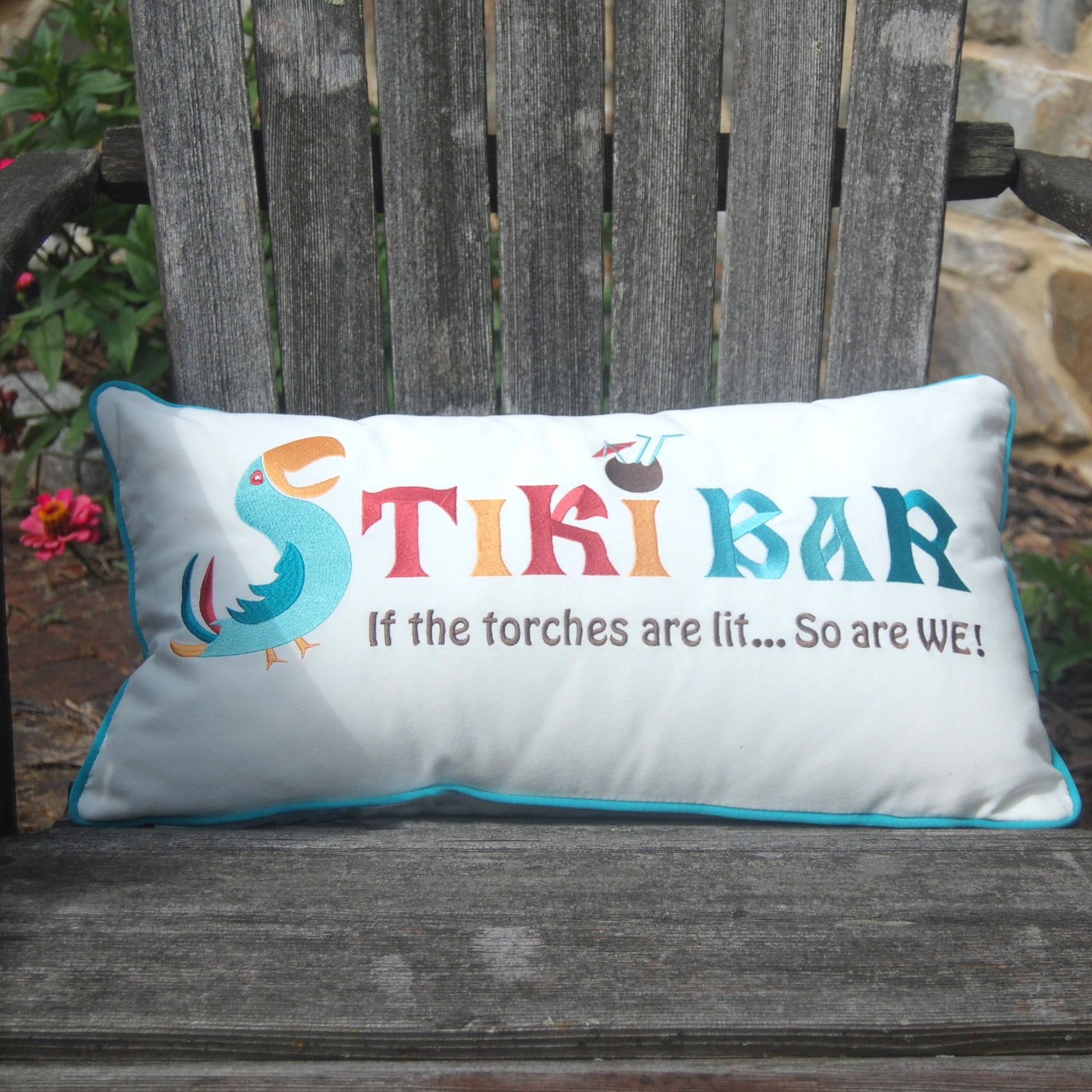 Tiki Bar Lumbar Indoor Outdoor Pillow styled on a wood Adirondack chair.