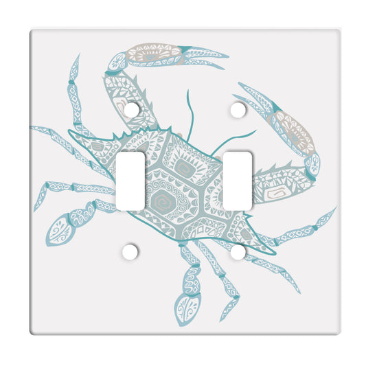 white ceramic double toggle switch plate featuring a graphic of a teal crab.