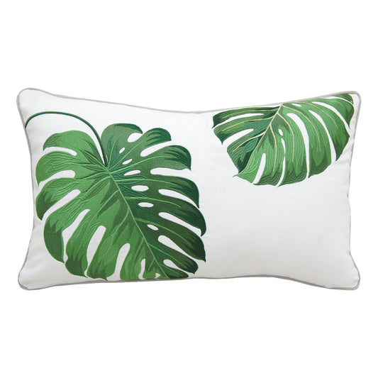 Two green tropical monstera leaves embroidered on a white background.