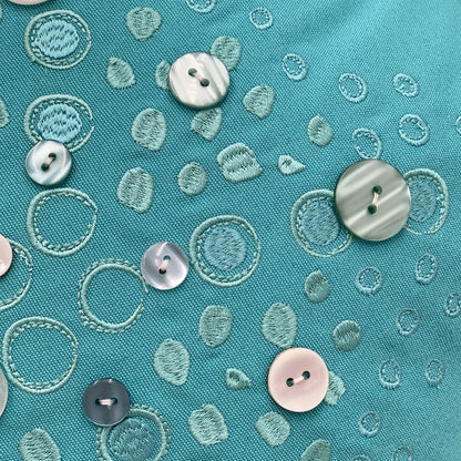 Detail shot of the embroidery work and beaded accents on the Turquoise Sea Star pillow.