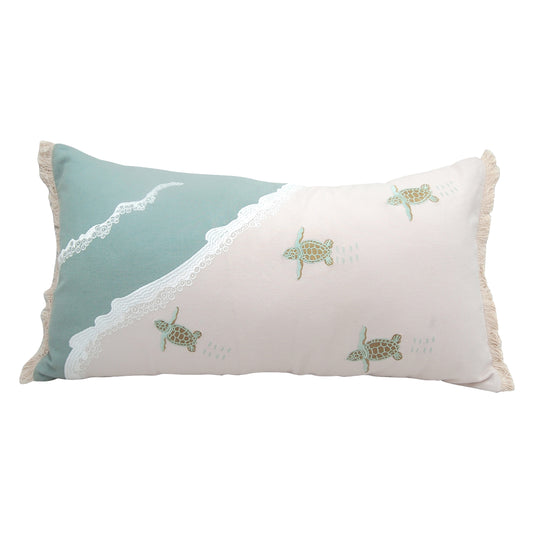 Four baby sea turtles embroidered on a lumbar pillow.
