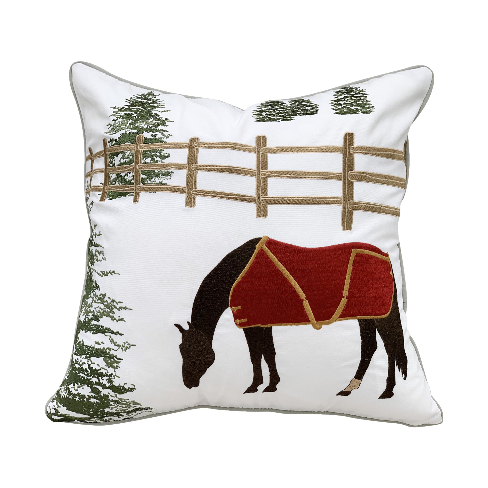 A horse grazing in a winter scene of pine trees and fencing embroidered on a white background.