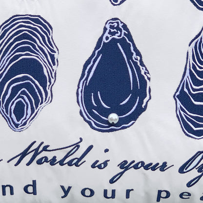 Detail shot of the World Is Your Oyster Indoor Outdoor Pillow.