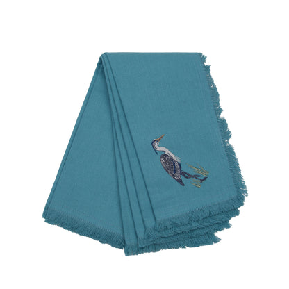 Blue Heron embroidered on blue cotton fabric with fringe edge. Set of 4 napkins.