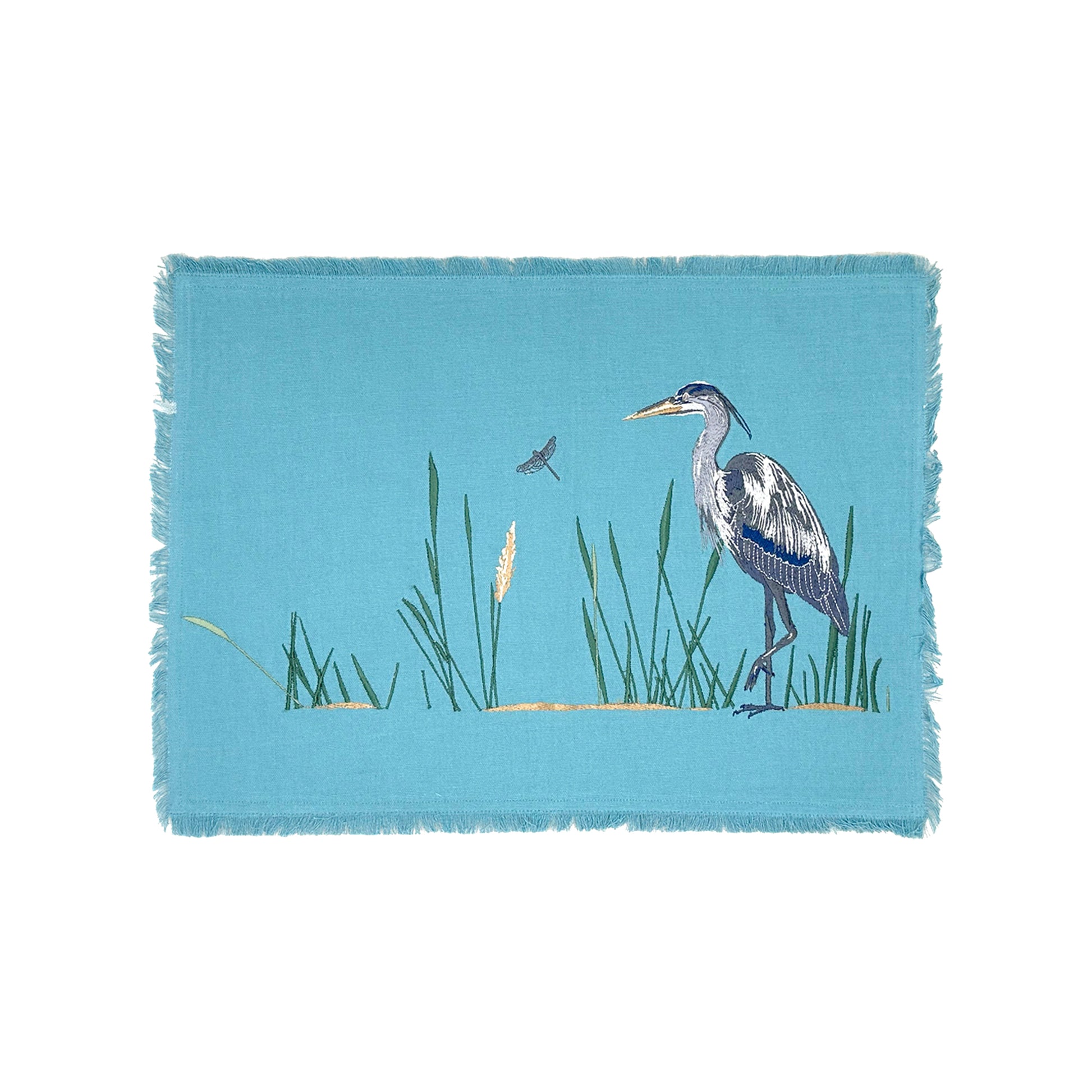 Blue Heron in the reeds with a dragon fly embroidered on blue cotton fabric with fringe edged placemat..