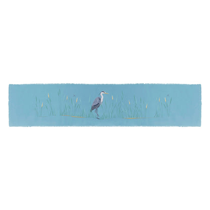 Blue Heron in the reeds embroidered on blue cotton fabric with fringe edged placemat..