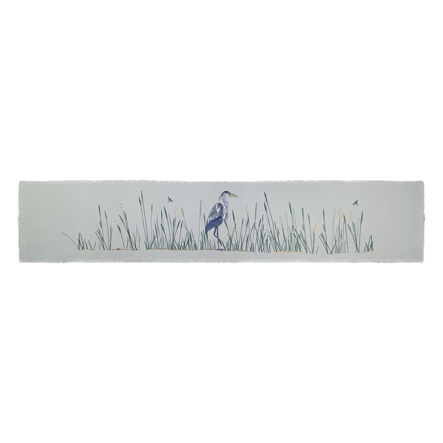 Grey cotton fringed table runner featuring embroidery of Great Blue Heron and reeds. 