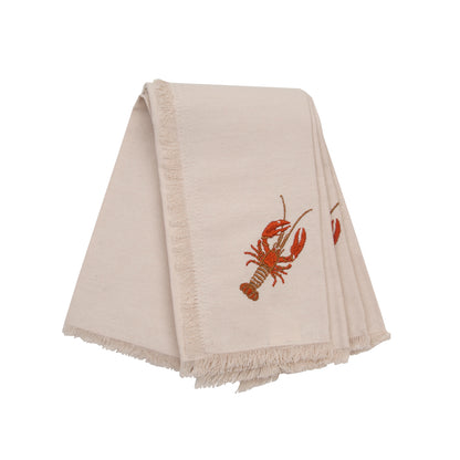 Natural fringed cotton napkins featuring embroidered red lobster.